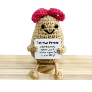 I have displayed the image you provided. Based on the visual and the text you shared, here is the suggested title:  "Emocjonalne wsparcie w postaci uroczej szydełkowej lalki-ogórka"