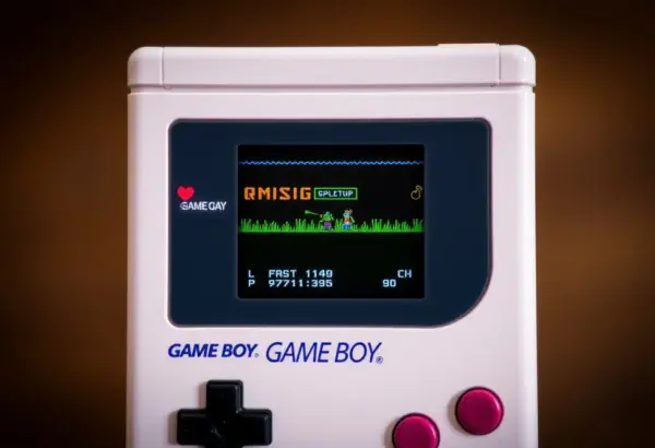 A Game Boy displaying a retro game with highlighted buttons and graphics.
